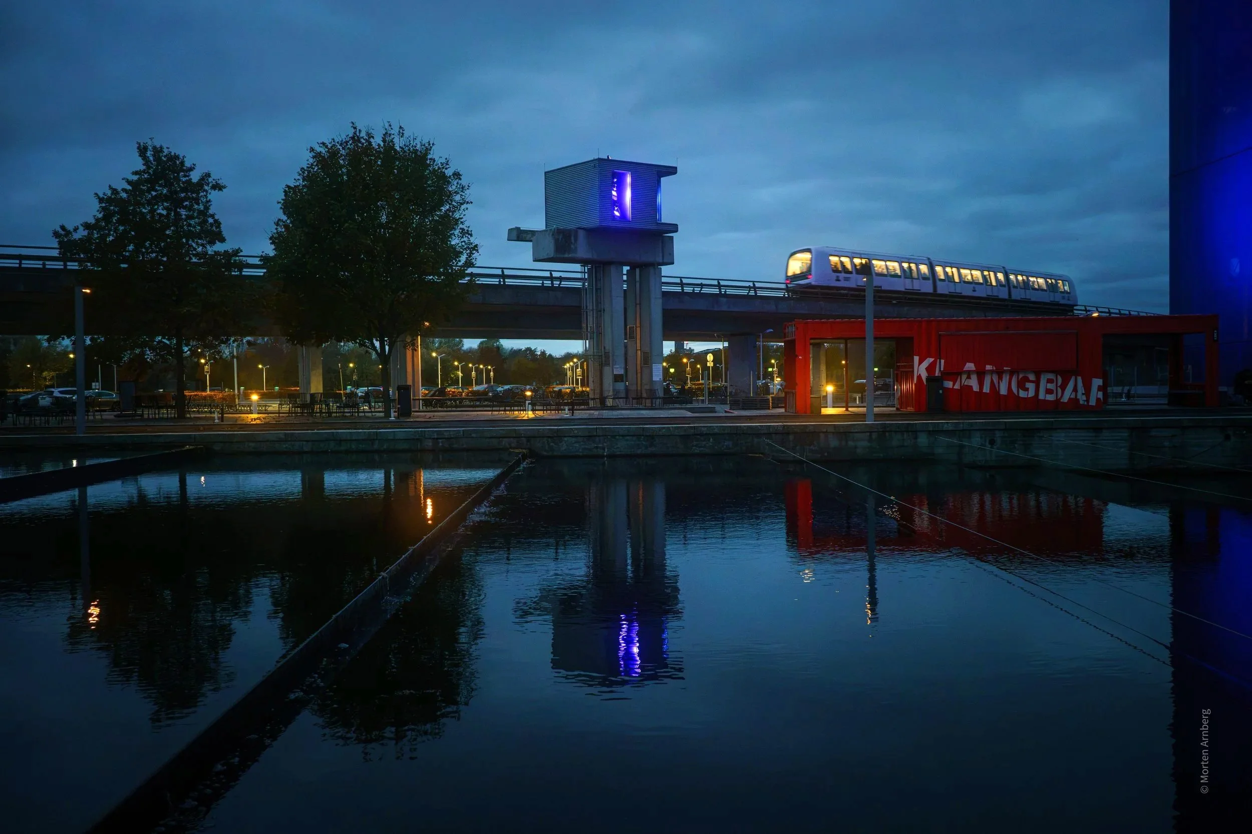 Water or glass, reflecting surroundings. 