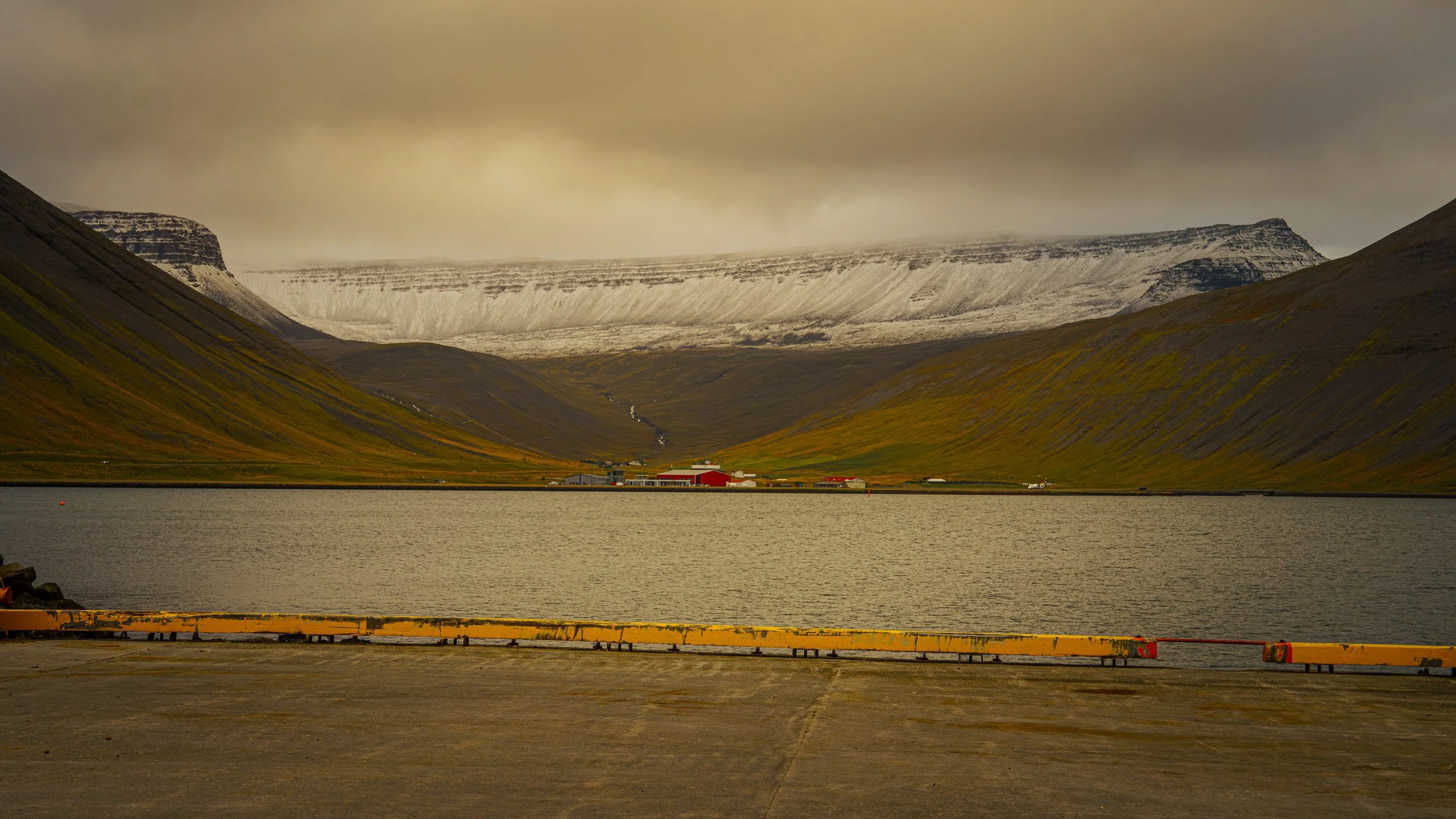 Isafjordur (Ísafjördur - Ice Fjord)) Fjord seen from Isafjordur. Fresh snow om the mountains signaling the end of the fall season.