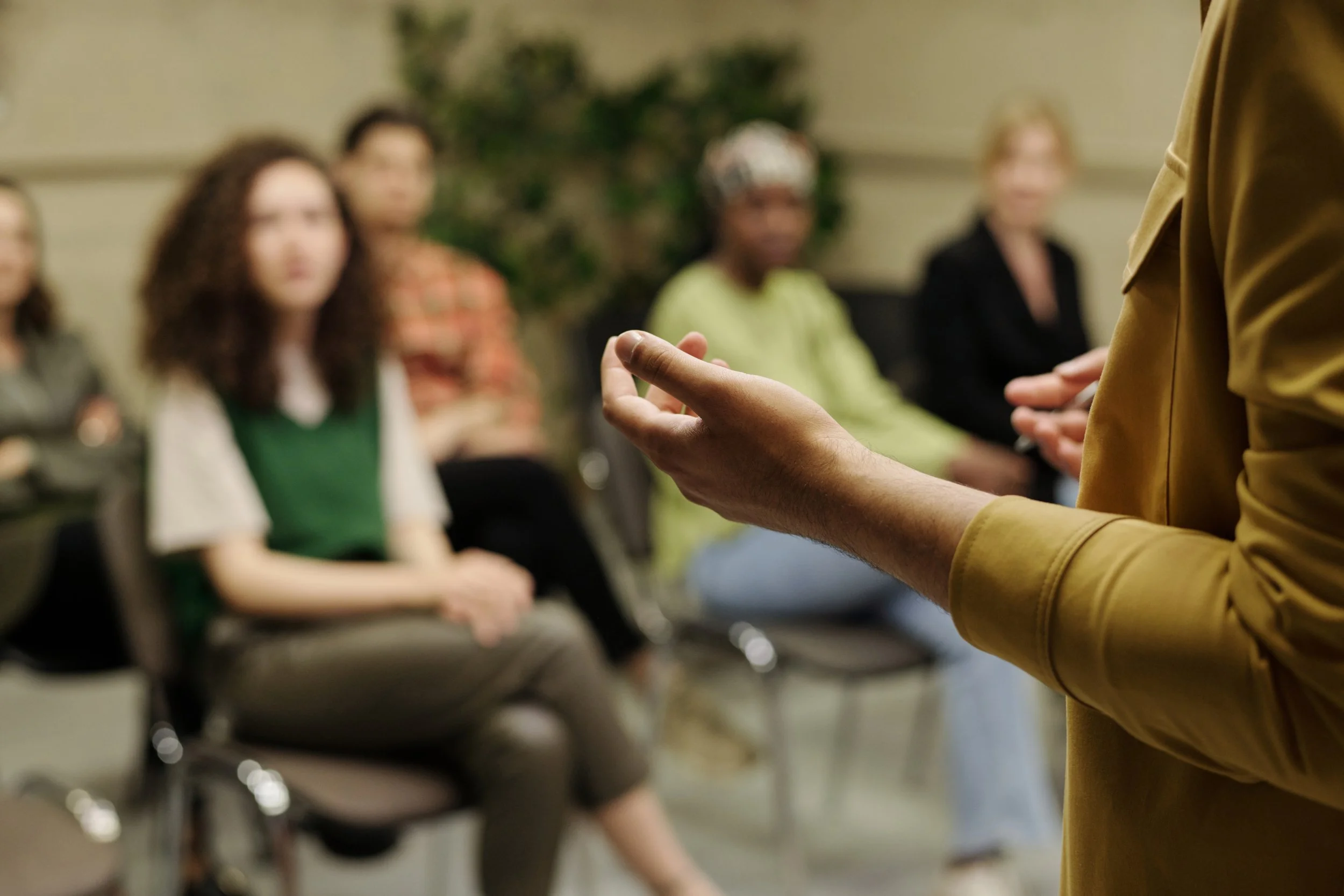 woman speaking infront of a group