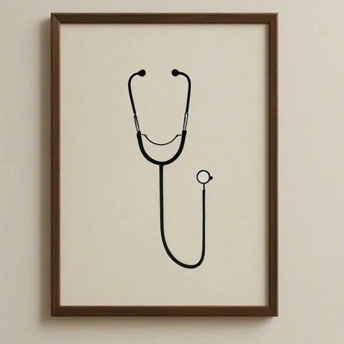Framed artwork of a stethoscope with the earpieces at the top and the tubing forming the shape of a smiling face.