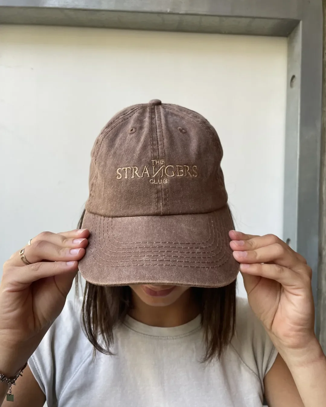 A cocoa brown vintage-style washed cotton cap with custom tan embroidery, showcasing Soli's sustainable branded merchandise and corporate gift options in Cape Town.