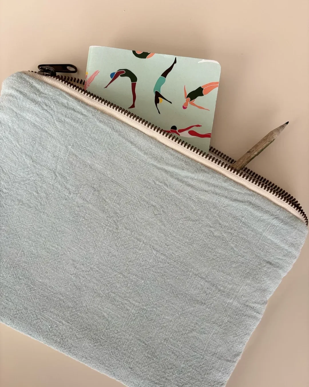 Eco-friendly Churchhaven pouch made from bio-softened light blue Ramie natural fiber, featuring a notebook and pencil, handmade in Cape Town by Soli.
