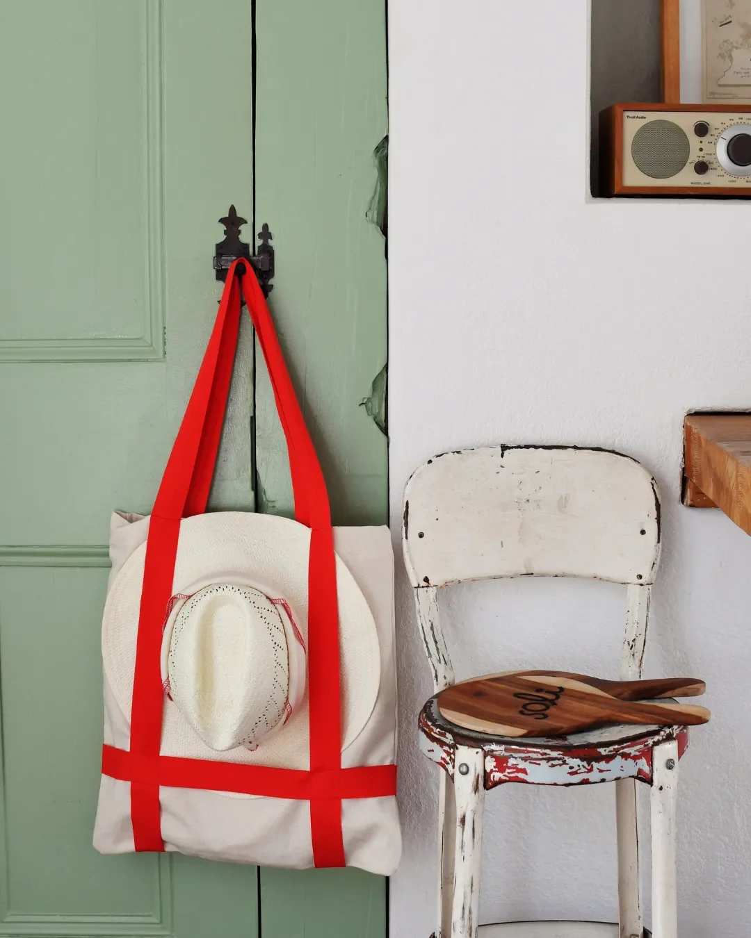 A  Vienna Tote bag handmade in Cape Town, featuring a yoga mat and sun hat secured by cotton straps, handmade in Cape Town by Soli for a custom yoga or pilates bag merchandise or corporate gift.