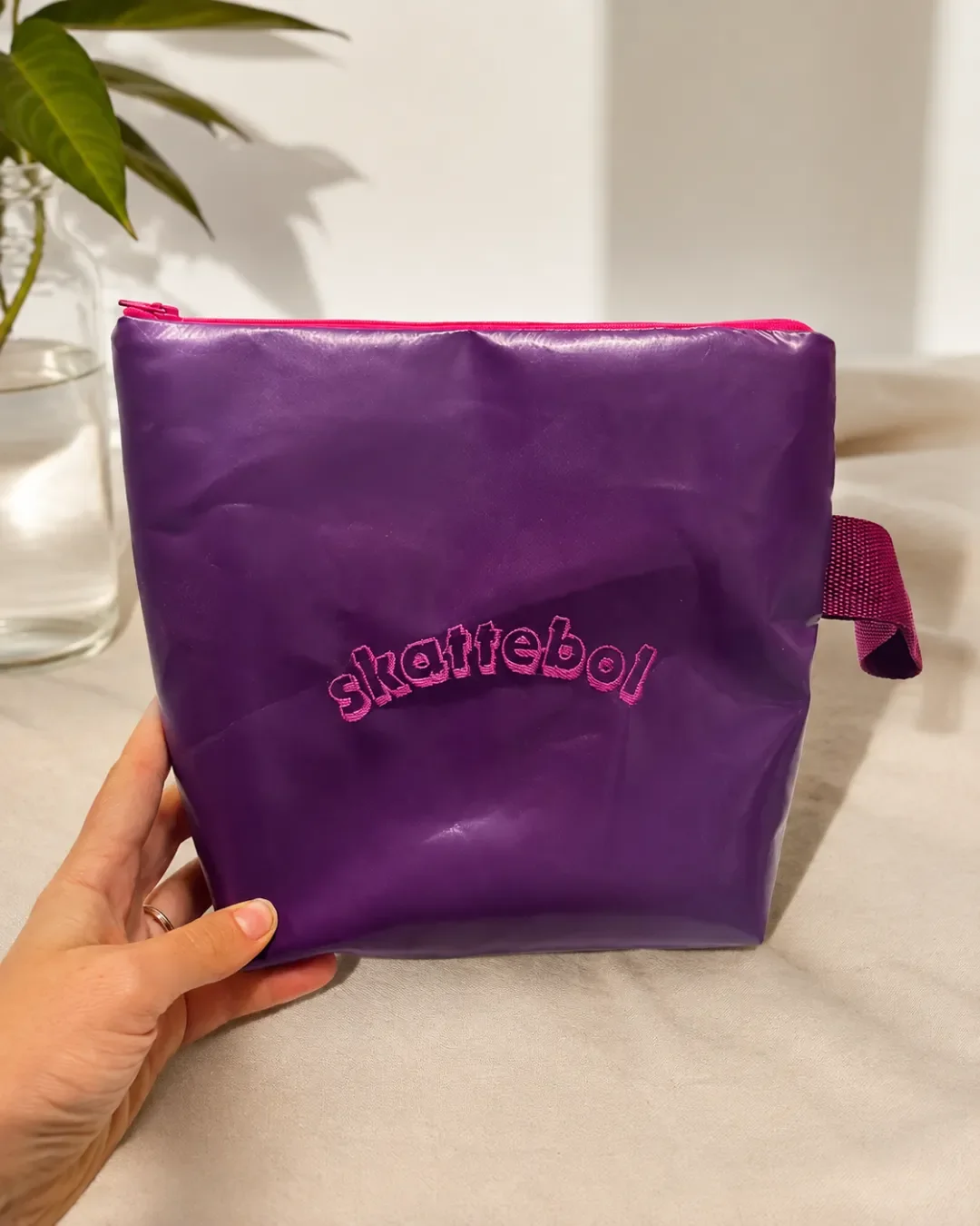 Custom purple skattebol makeup bag made in Cape Town, South Africa, featuring durable vinyl and a pink zipper.