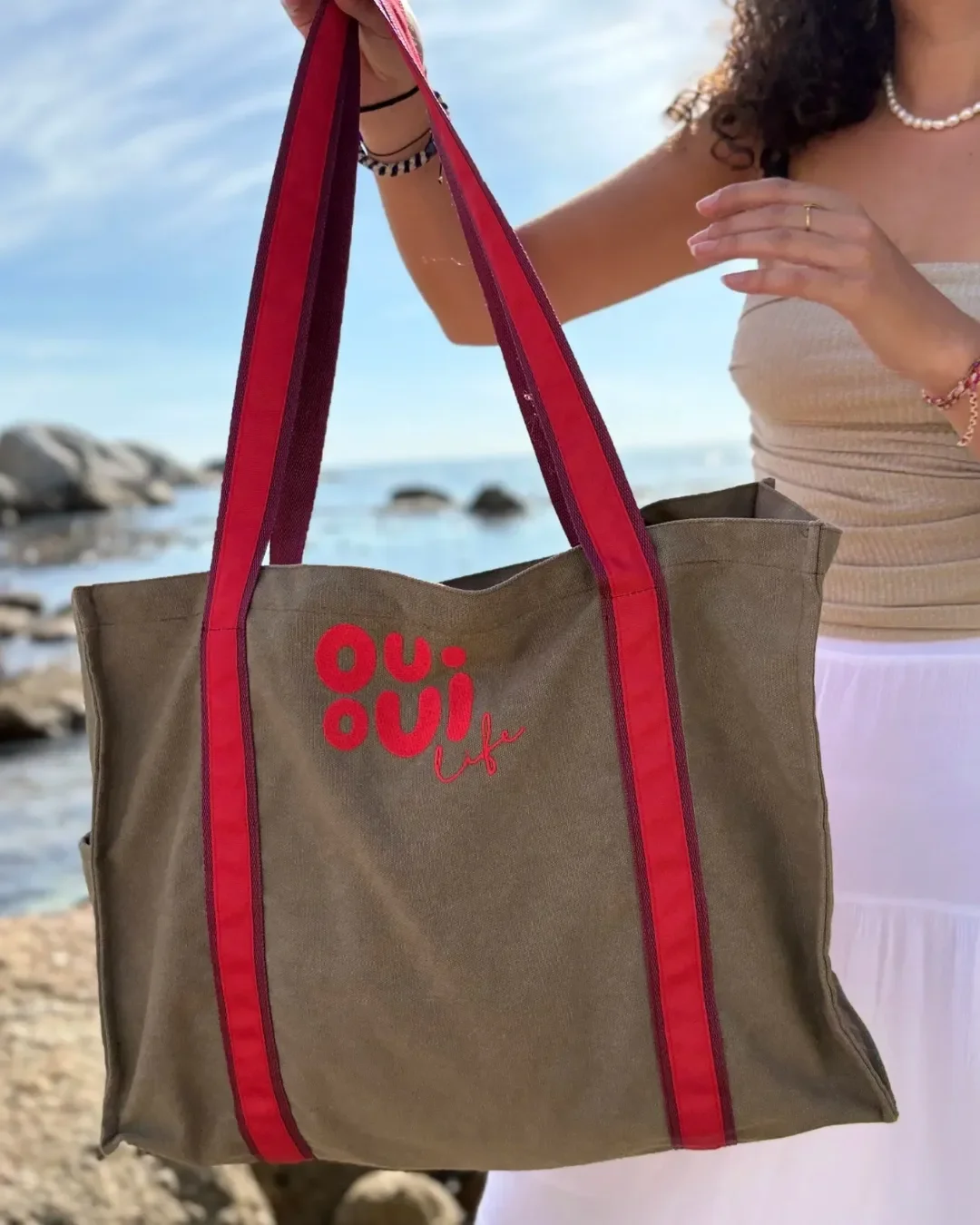 Large buckskin washed canvas fire bag with red striped handles and custom embroidered logo. Handmade by Soli in Cape Town for sustainable merchandise or corporate gifts.