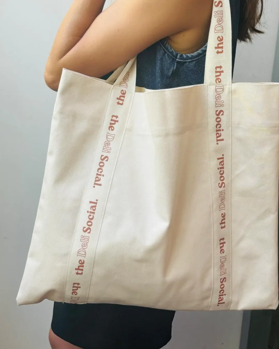 Custom branded signature strap bag in natural bull denim with personalized pink  logo handles. Handmade by Soli in Cape Town for sustainable merchandise or corporate gifts.