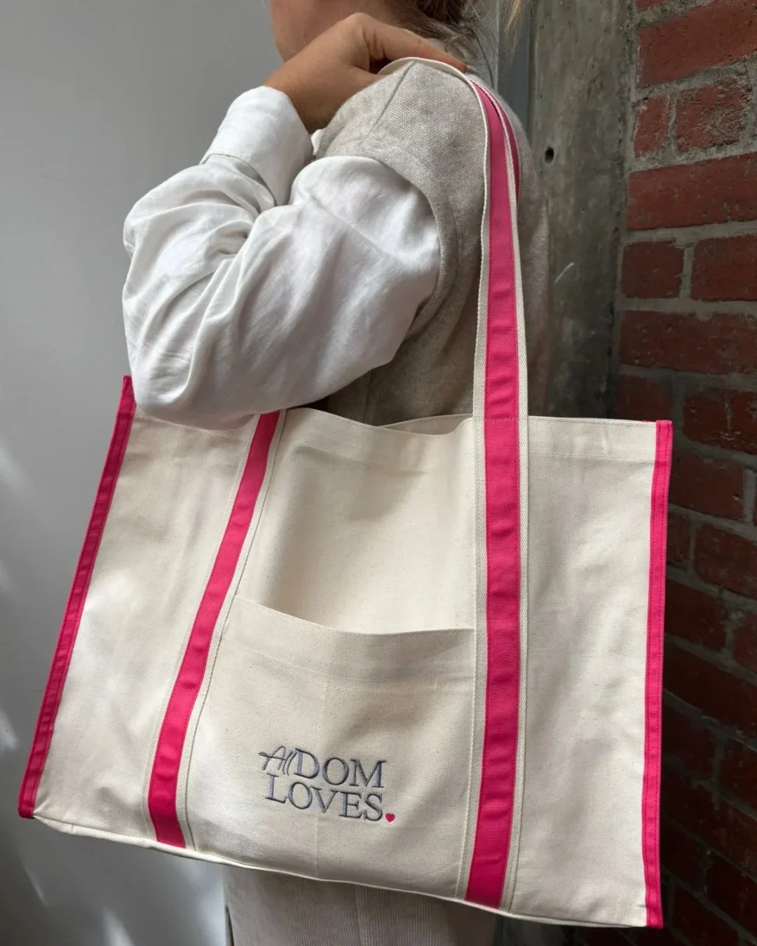 Handmade canvas Diesel Bag with pink trim and embroidered All Dom Loves logo, custom tote bag for sustainable merchandise, handmade by Soli in Cape Town for sustainable merchandise or corporate gifts.