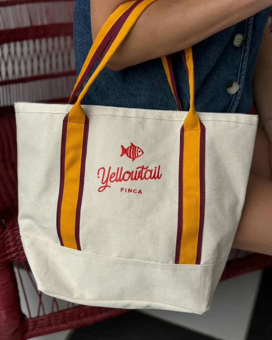 Oxford bag in cream 100% cotton canvas with bespoke Yellowtail embroidery and striped handles. Handmade by Soli in Cape Town for sustainable merchandise or corporate gifts.