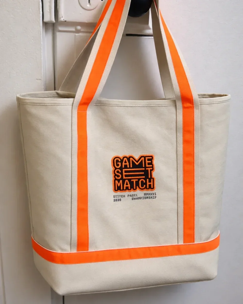 Cream cotton canvas Oxford tote bag with orange trim and custom embroidery, handmade by Soli in Cape Town for sustainable merchandise or corporate gifts.
