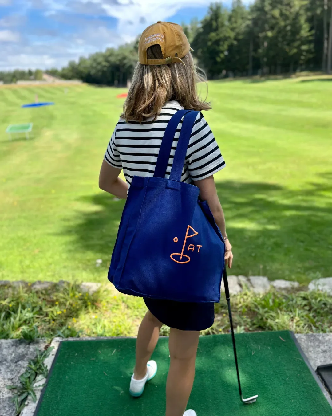 Custom sustainable navy blue tote bag with orange embroidered logo, handcrafted in South Africa by Soli for corporate gifts. merchandise and amenities.