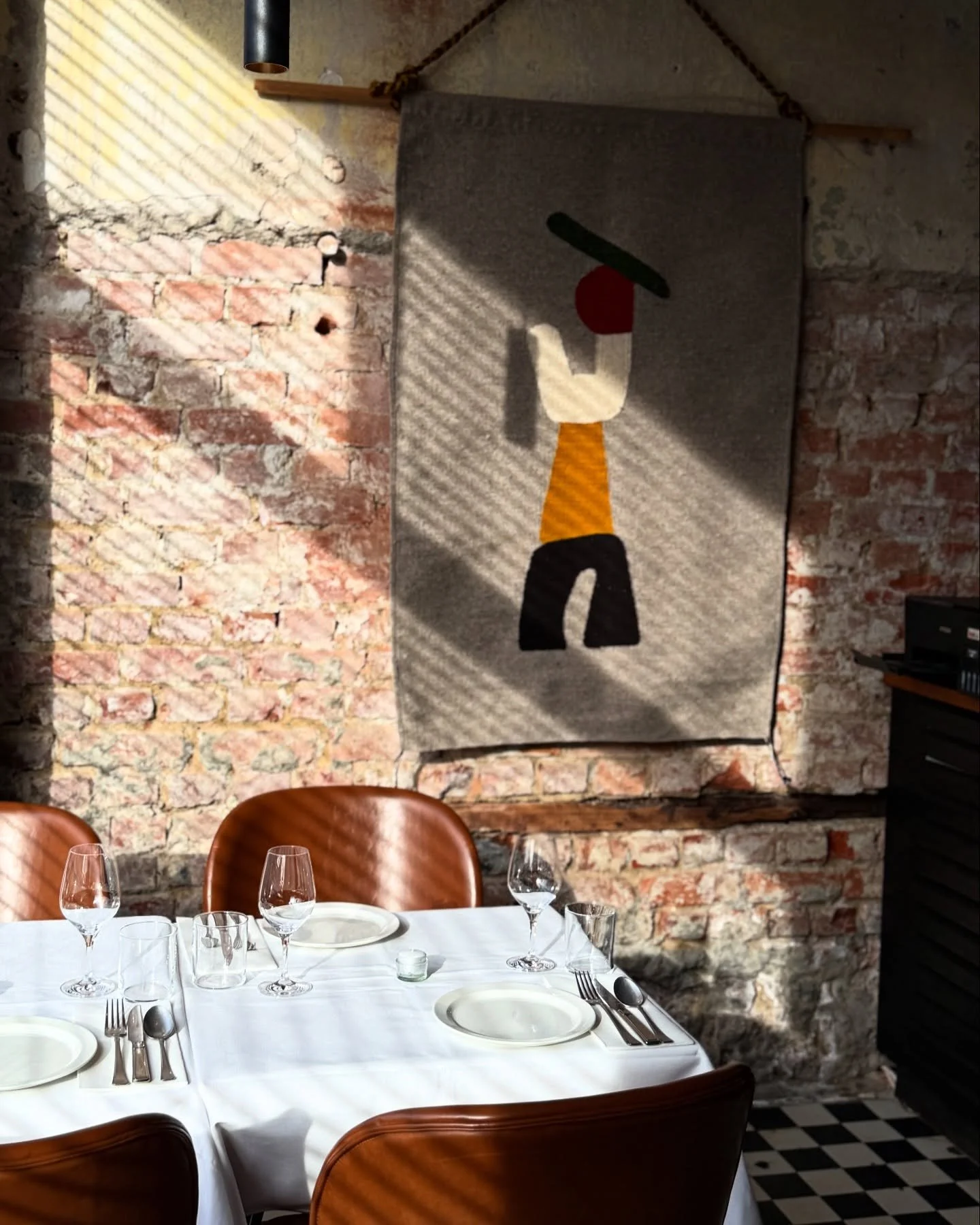 Table 8. Tucked away at the far side of our restaurant, flanked by large windows out onto the sidewalk on the left and a small view of the action in the kitchen behind. 

Handwoven wool tapestry by @____m.a____
