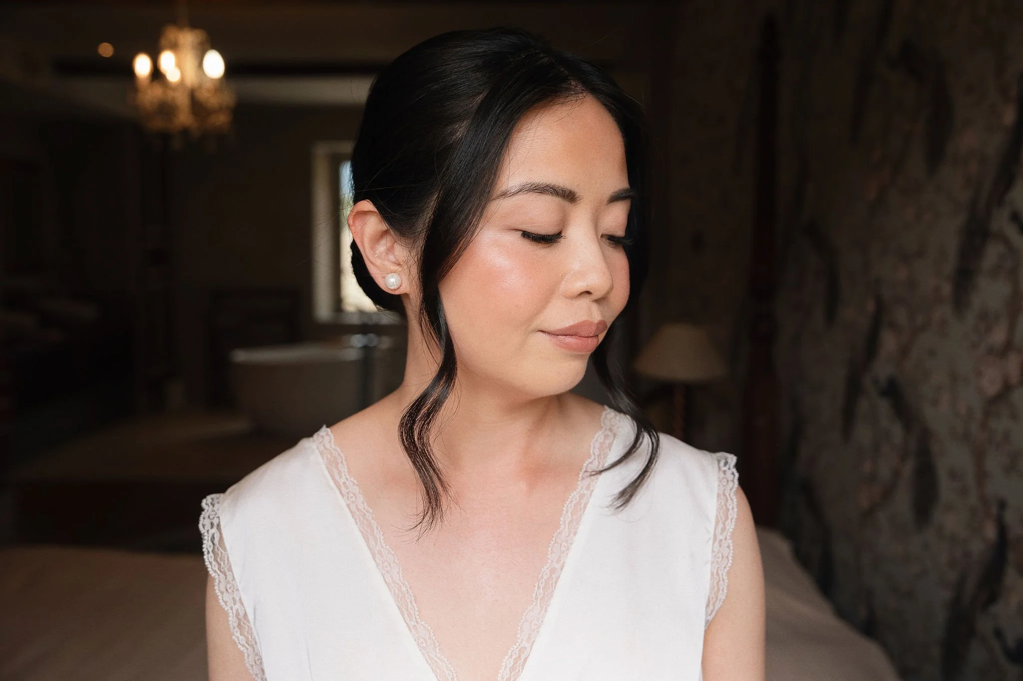 Bride with soft natural makeup and romantic low bun, bridal makeup artist in Provence, Château de Méouilles wedding