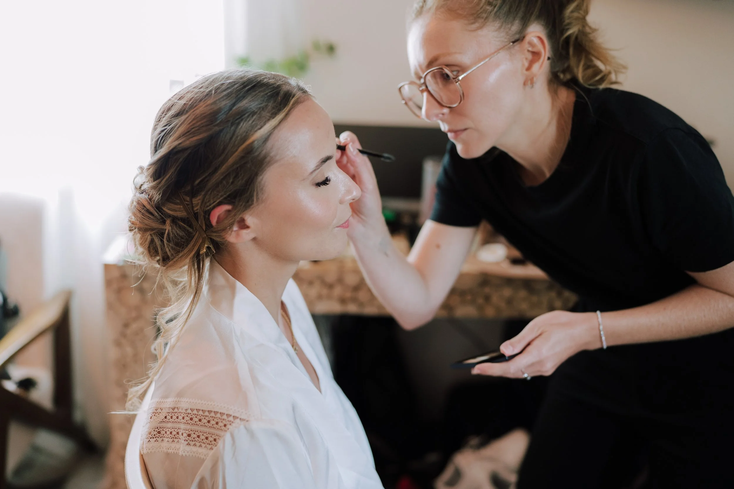 Mathilde Vintze applying bridal makeup to a bride on her wedding morning in Provence