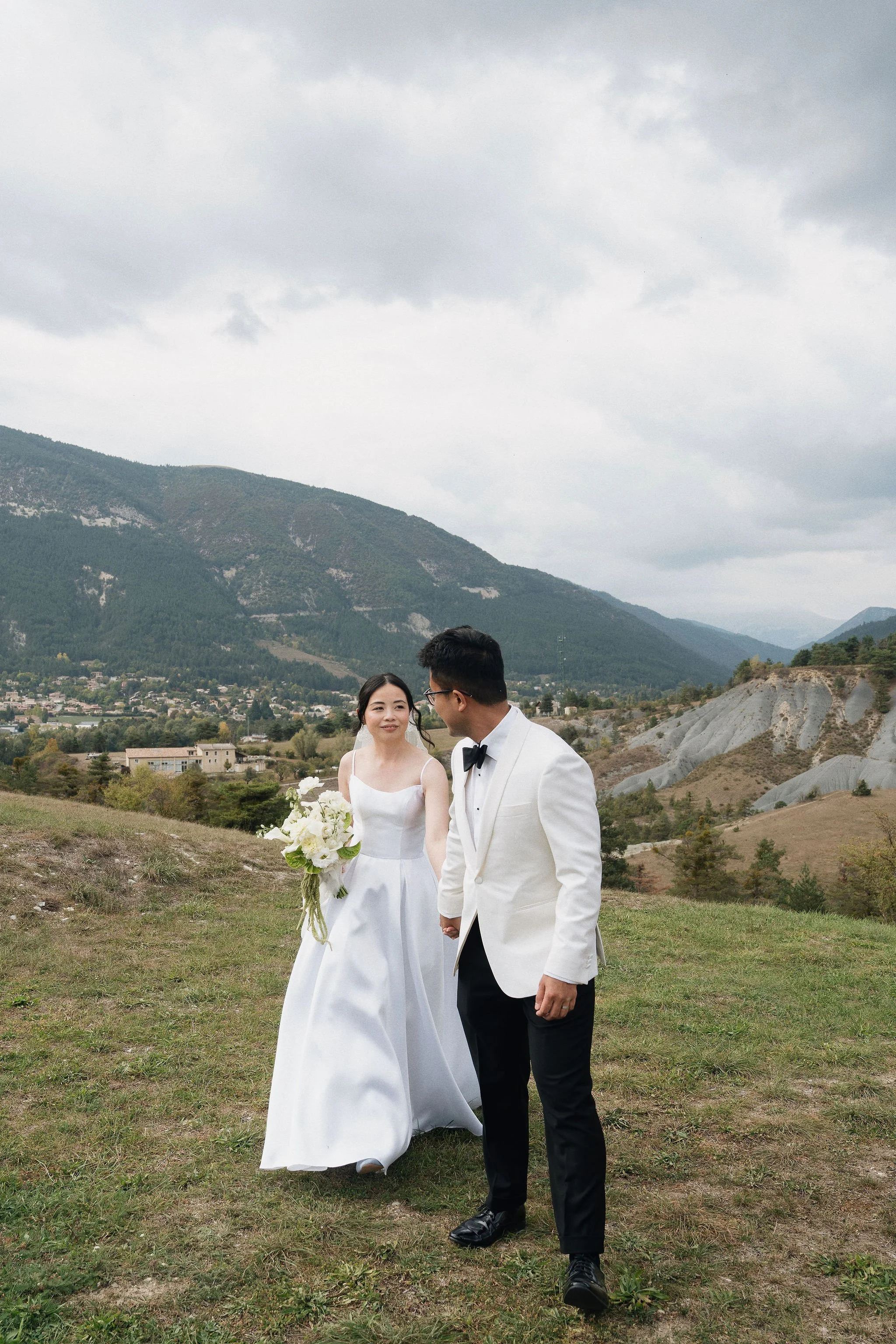 Bride and groom walking in the Alps at Château de Méouilles, natural bridal makeup by Mathilde Vintze, Provence wedding makeup artist