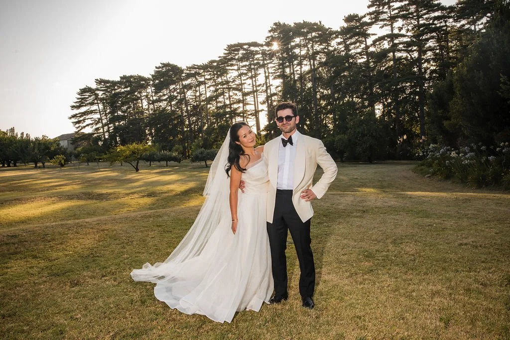 Bride and groom in an ivory dinner jacket on the château lawn at golden hour, Château de Beauregard wedding in Provence, France