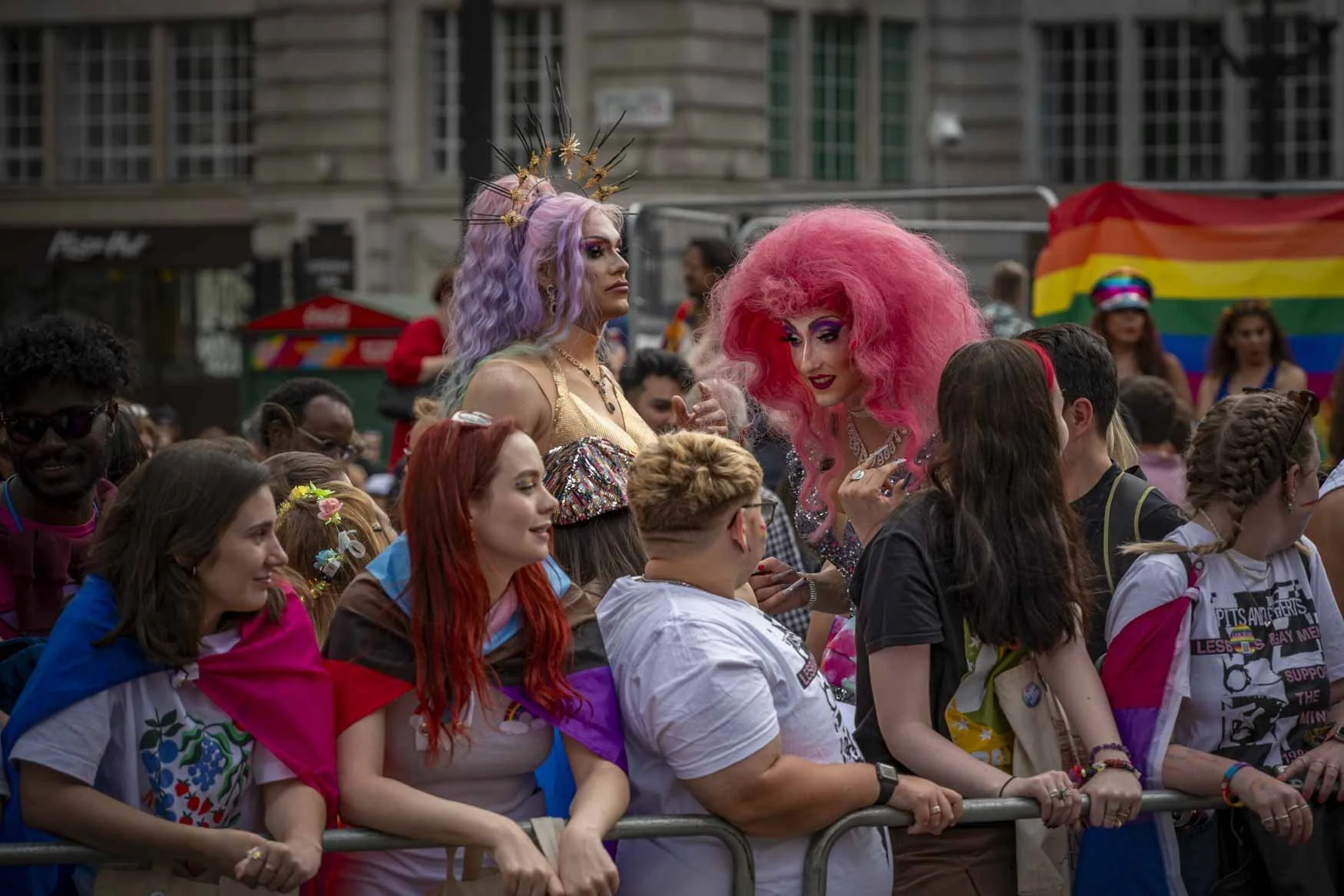 In Conversation.
On the sides of the Pride Parade, London 2022. A moment in the crowds waiting for the parade to pass by.  
Kappa Printing 75x50cm Connect for Price 
