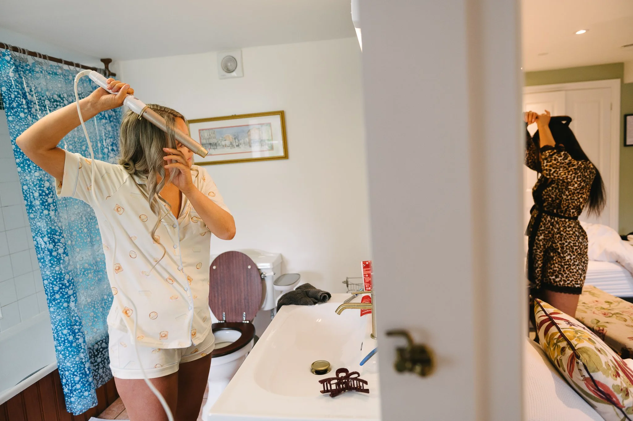 Bridesmaids getting ready in two rooms