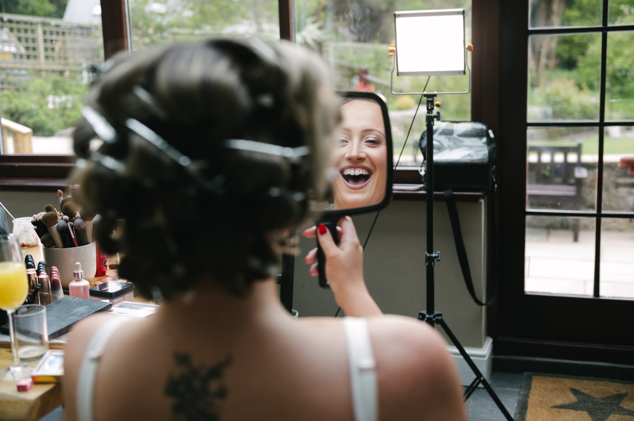 Jess the bride seeing her makeup in the handheld mirror