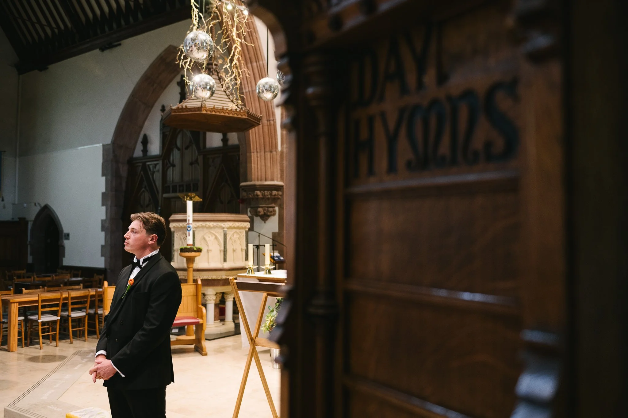 Ed the groom waiting patiently at the altar in Peel Cathedral