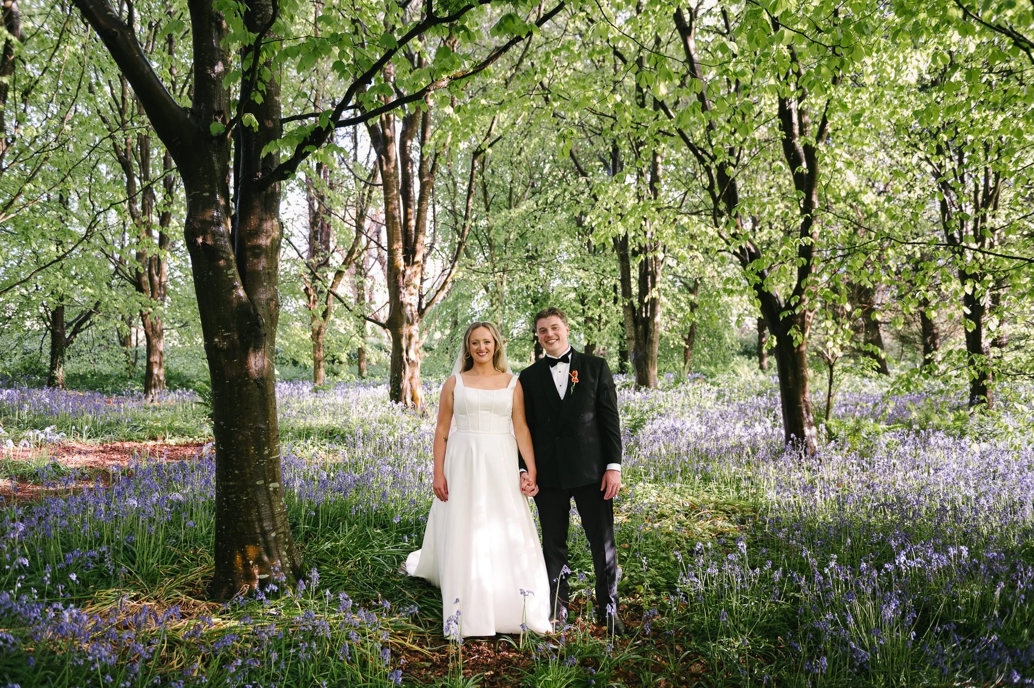 Bride &amp; Groom in the woods at The Mill House surrounded by bluebells