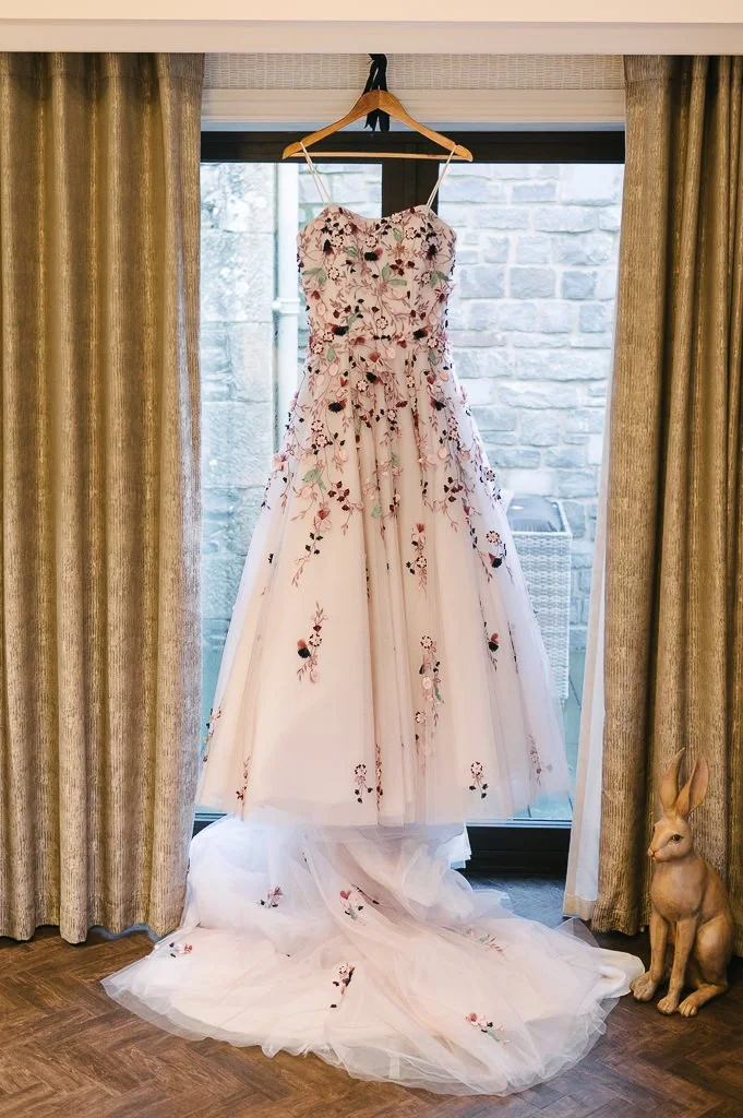 Wedding dress hanging in the window York wedding photographer