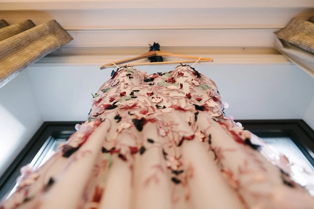 Wedding dress hanging in the window York wedding photographer