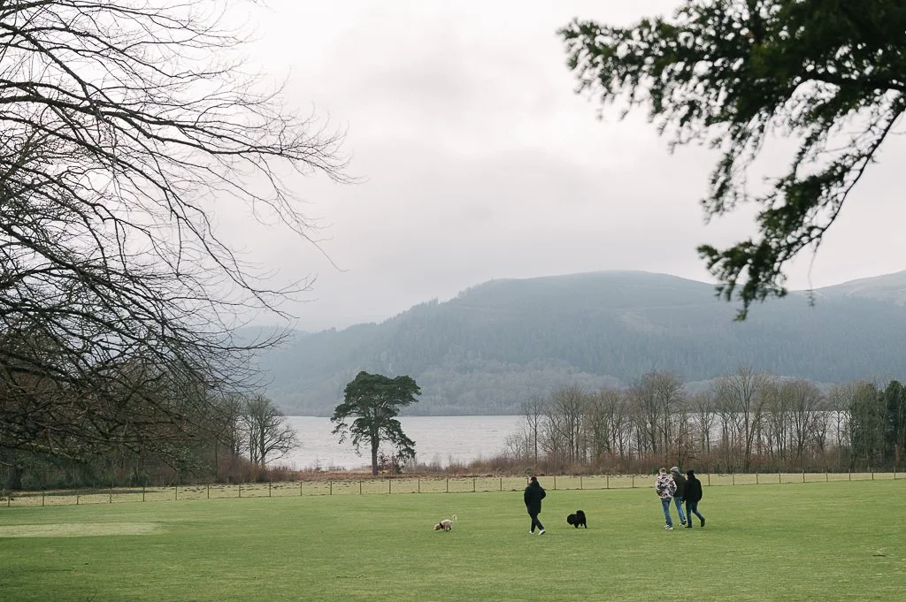 Groom and ushers take the dog for a walk to lake bassenthwaite