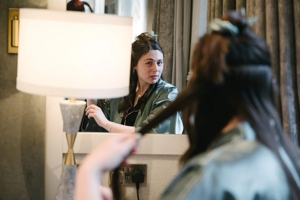 York wedding photographer - Bridesmaid getting ready in the mirror