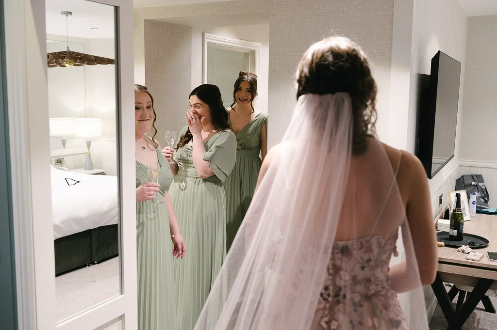 Everyone looking at the bride in her dress Leeds wedding photographer