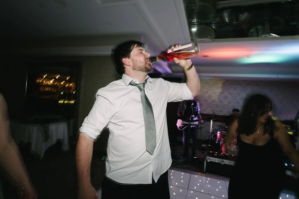 Wedding guest finishing the wine off