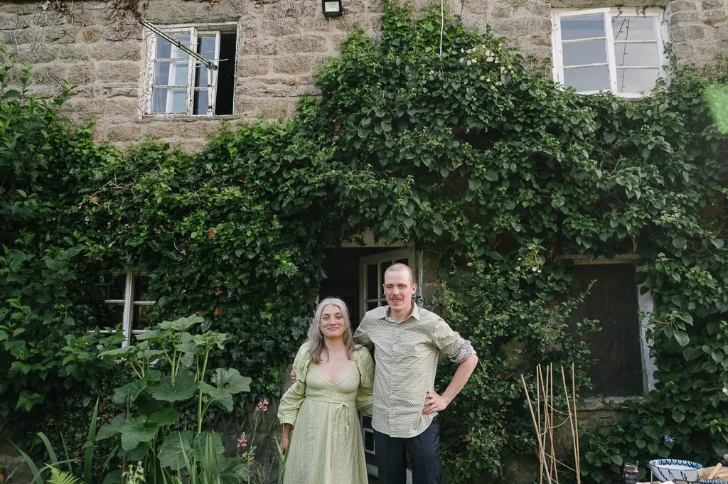 Bride and groom in front of the farm house