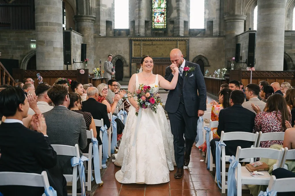 Bride and groom walking up the aisle at Left Bank wedding venue in Leeds