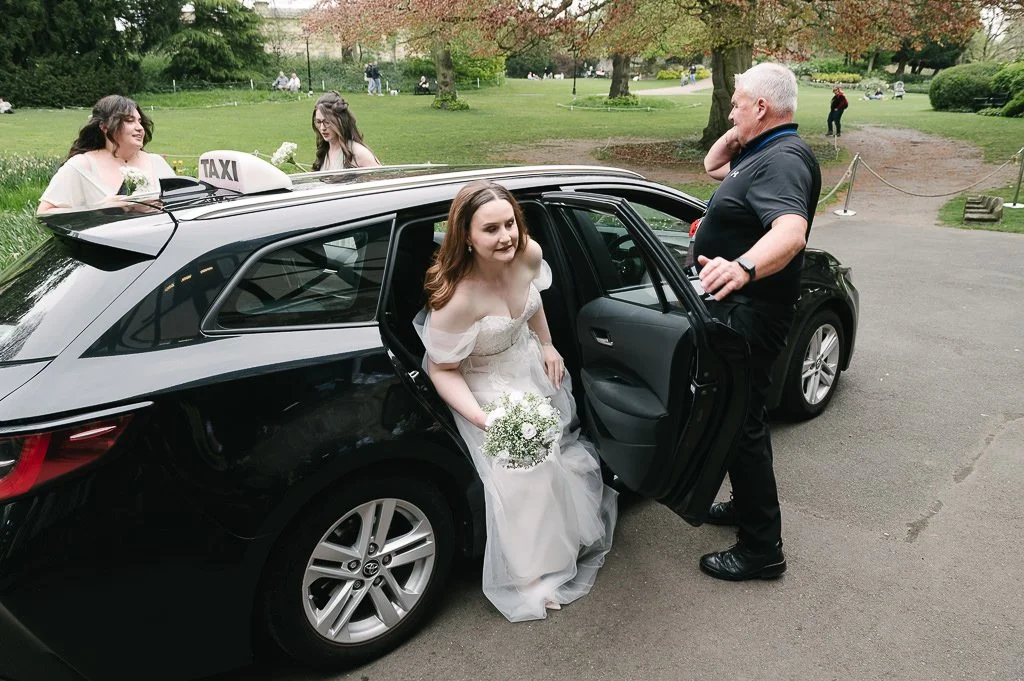 Bride getting out of the wedding car
