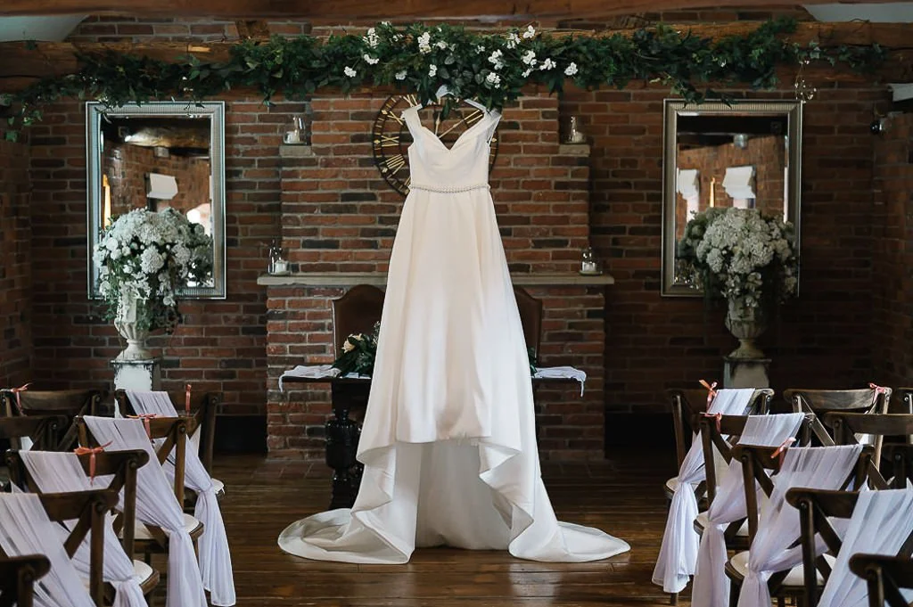 Brides dress hanging up in the ceremony room at Swancar farm Nottingham