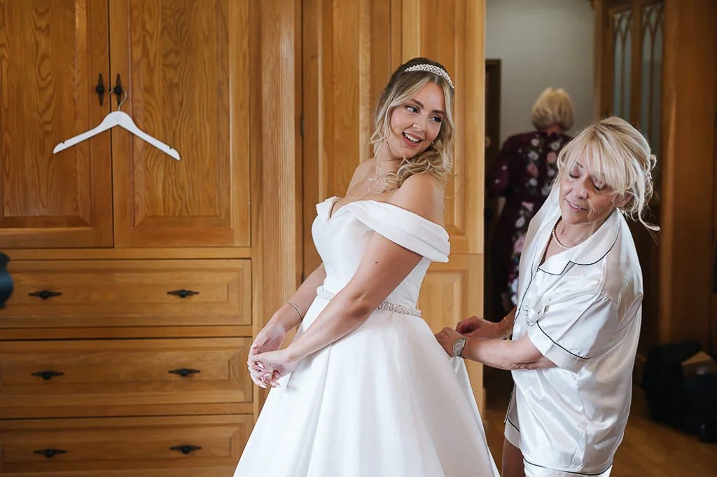 fastening the bride's dress