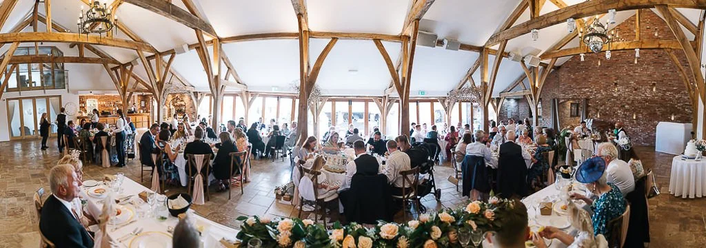 Panoramic photograph of all the guests waiting for food at Bella &amp; Toms Nottinghamshire wedding