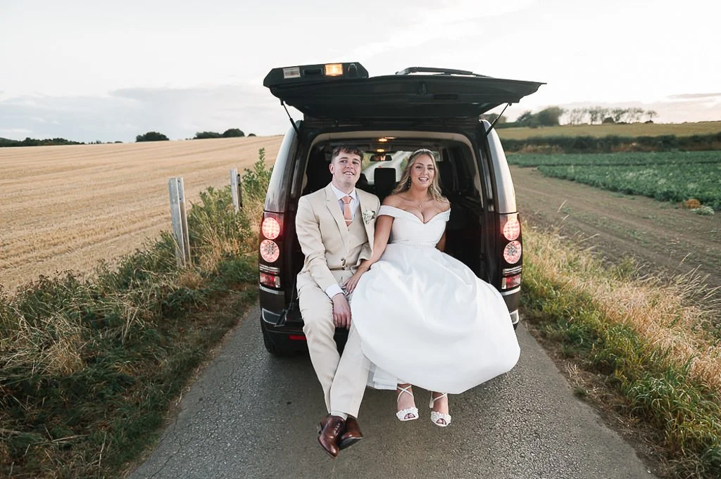 The Bride and groom hitch a ride back to the venue