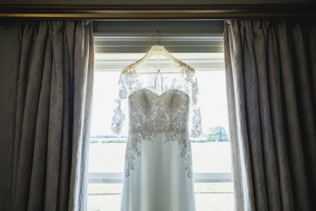Wedding dress hanging in the window