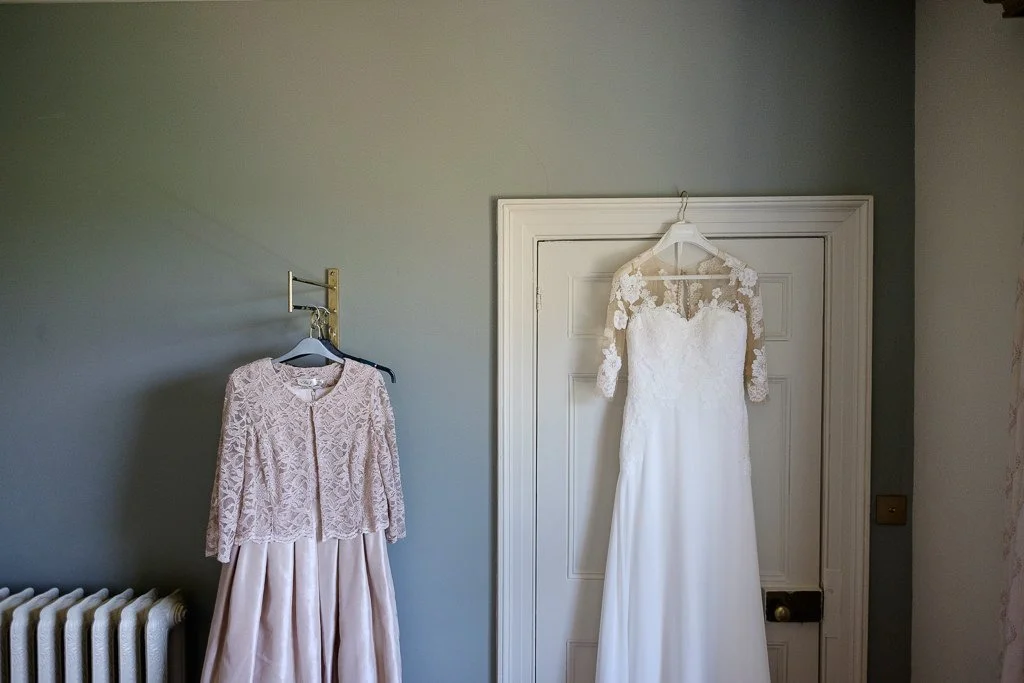Brides dress and Mother of the brides dress hanging on the wall