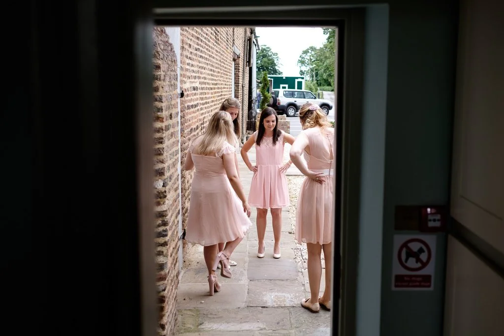 Bridesmaids examining their outfits
