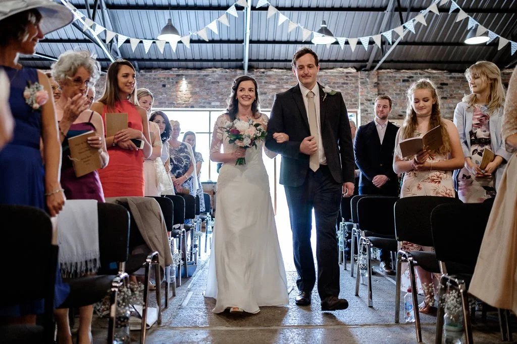 The bride and her dad walking down the aisle
