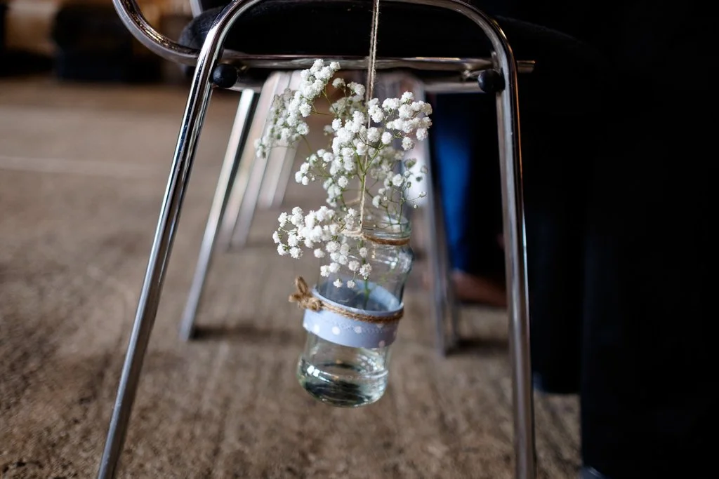 Flowers decorating a chair at the ceremony