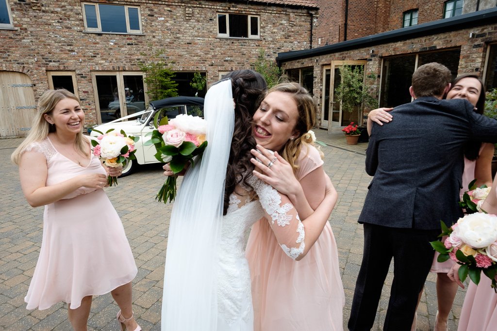 Hugs for the bride from one of her bridesmaids
