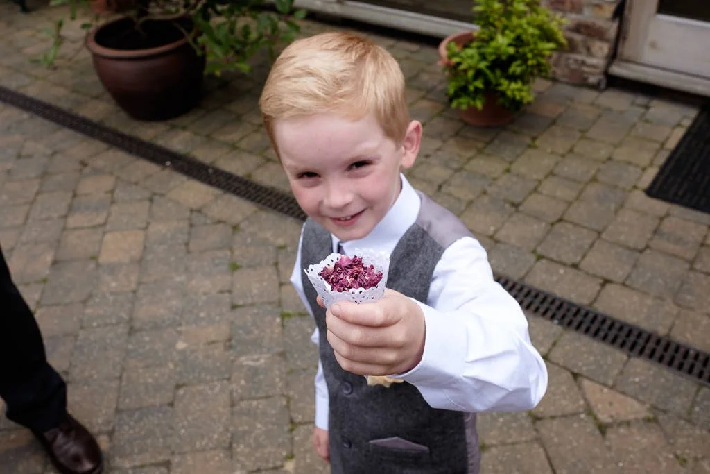 Small guest showing me his handful of confetti