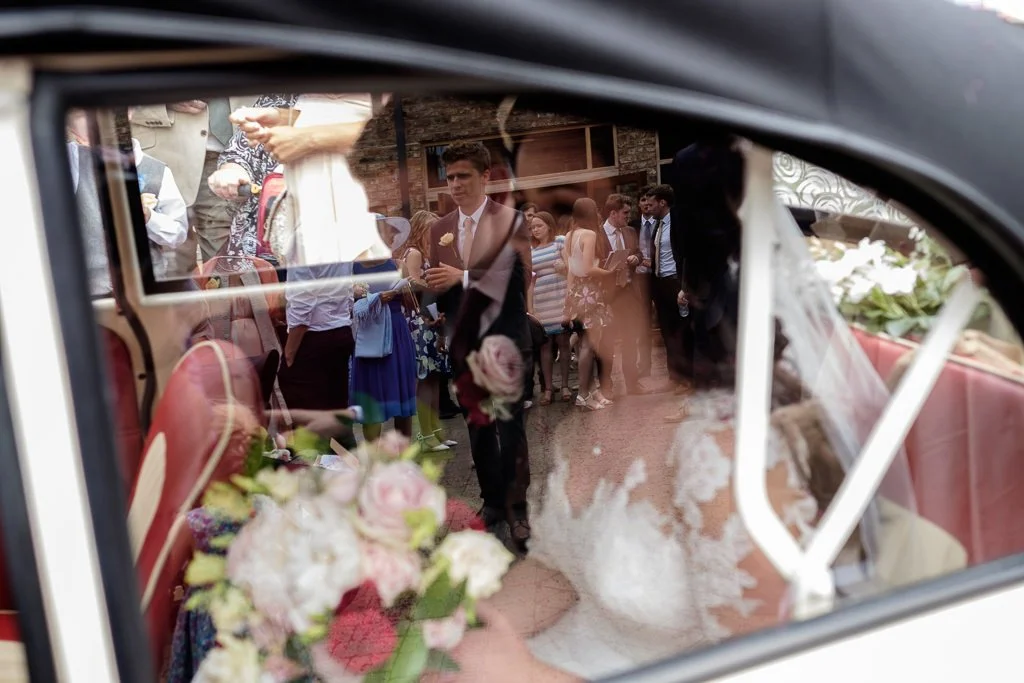 Bride &amp; Groom in the wedding car