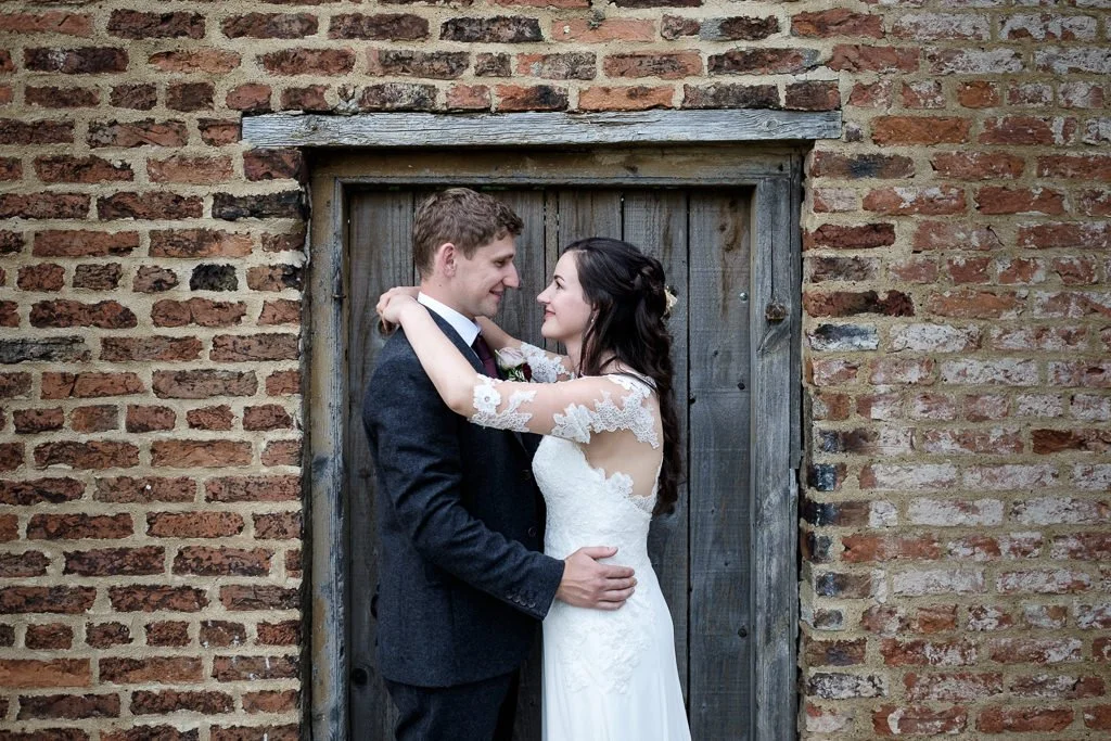 Becky and Josh wedding portrait in front of an old door