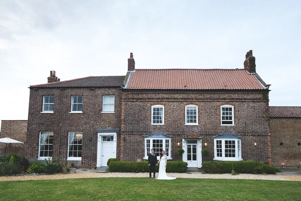 Bride &amp; Groom portrait in front of Hornington Manor farmhouse