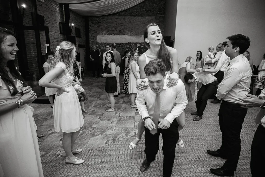 Groom giving the bride a piggy back