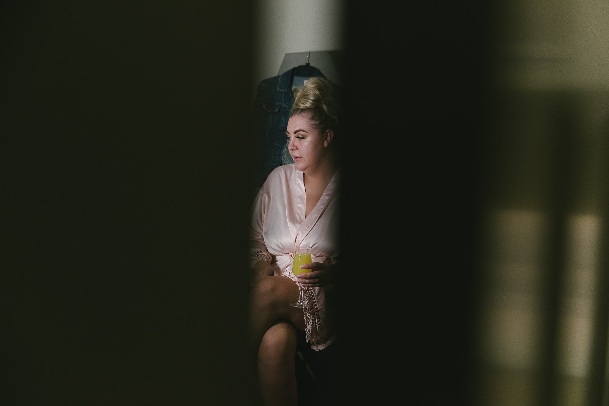 Bridesmaid through a crack in the door