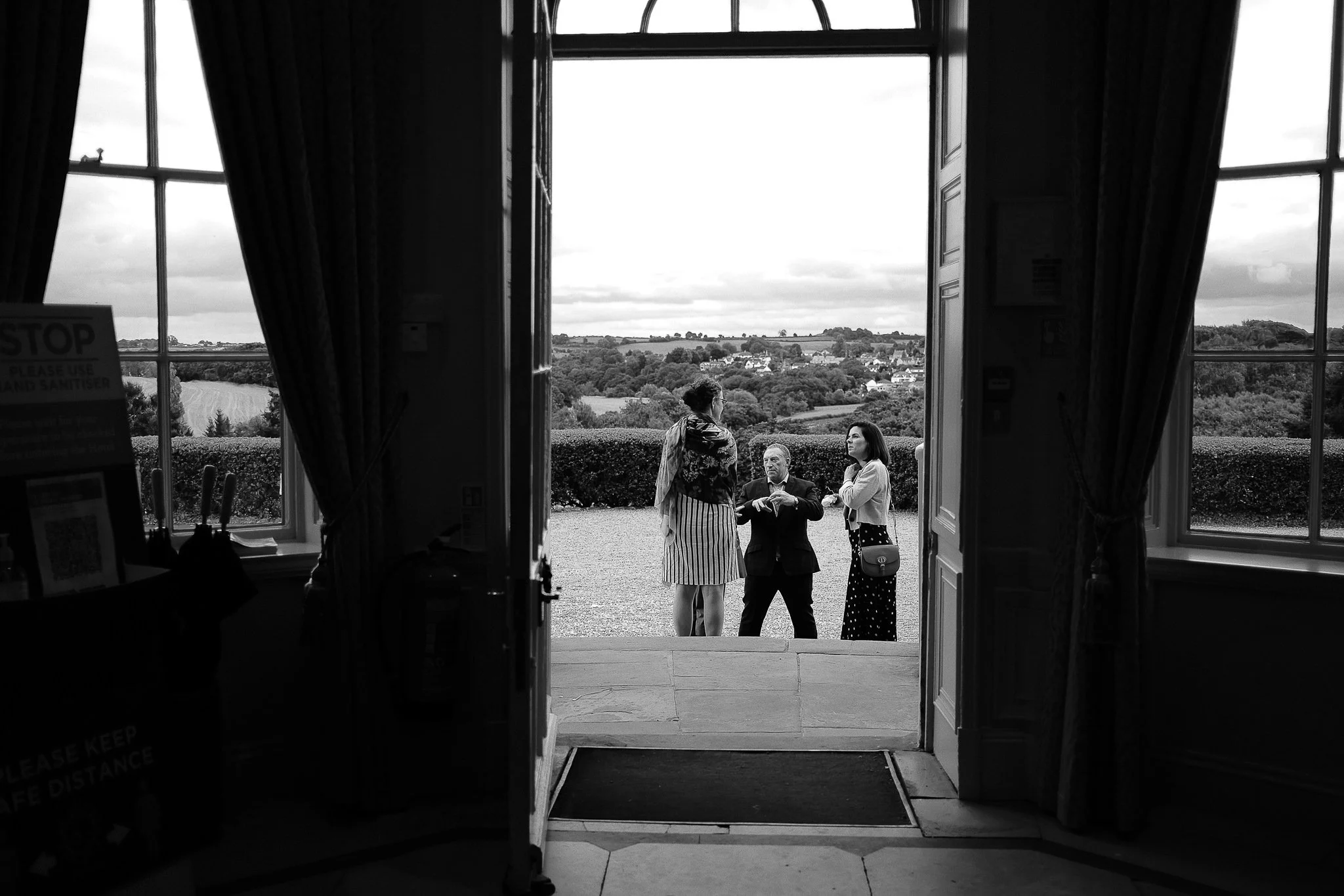 wedding guests outside through the main door at Wood Hall
